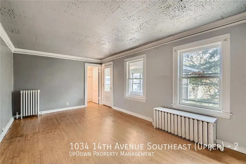 "Charming 2-Bed Upper Unit with Gleaming Hardwood Floors in Vibrant SE Como Neighborhood!" — Photo 4