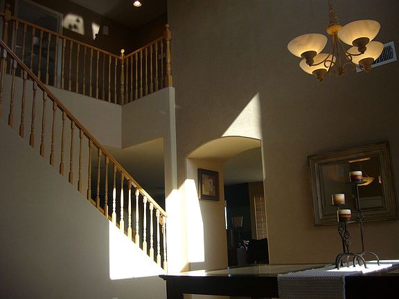 Living & Dining Areas: Ralph Lauren paint, vaulted ceilings, & oak railing