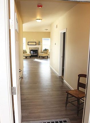 Open the front door to rich laminate floors and white painted trim!