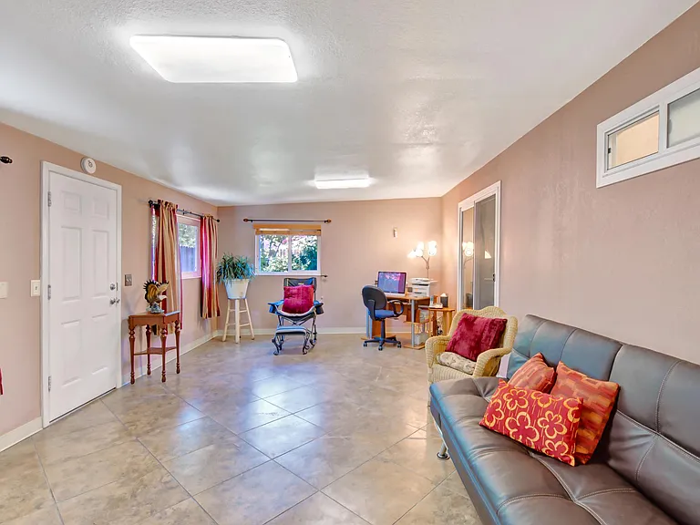 View of family room seen from the dining room. Door on the left leads to back yard, door on the right leads to master bedroom.