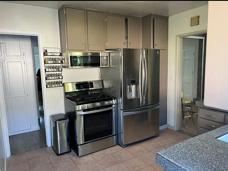 Kitchen has lots of storage, stainless steel appliances included - gas range, microwave, refrigerator