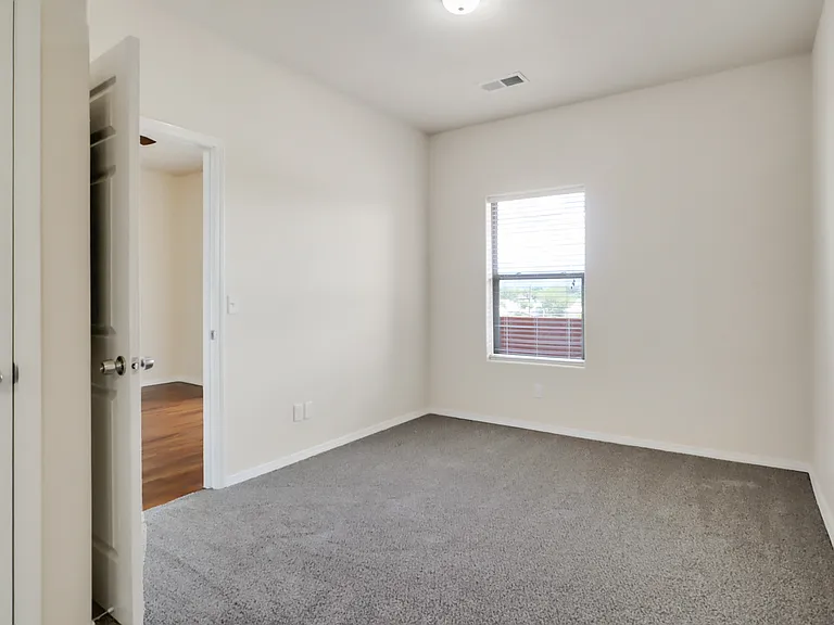 Unit 310 Bedroom looks out onto private balcony