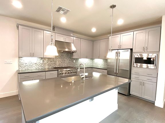 large professional kitchen with premium 36" range and large fridge