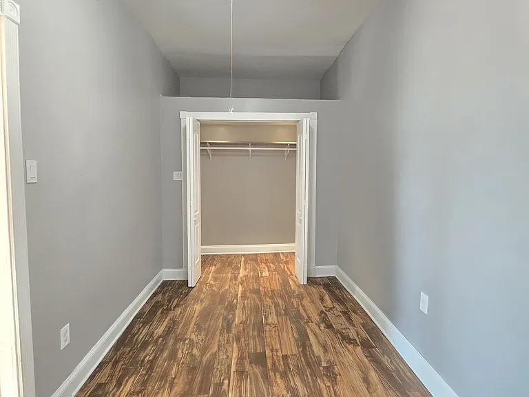 Bedroom 1 with large storage space above closet