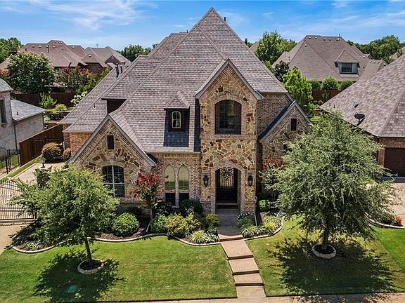Sits very pretty on the lot and surrounded by other custom homes that are very well kept as well. Additional privacy and security with the electric iron gate with a pass thru gate that is hidden by the tree on the left