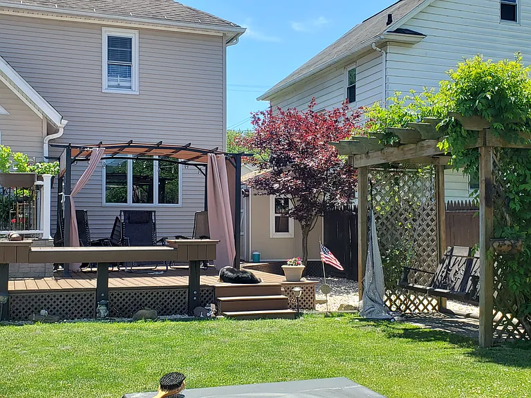 View of back porch / house / fenced in yard