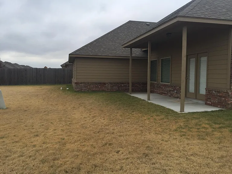 large backyard with full fence