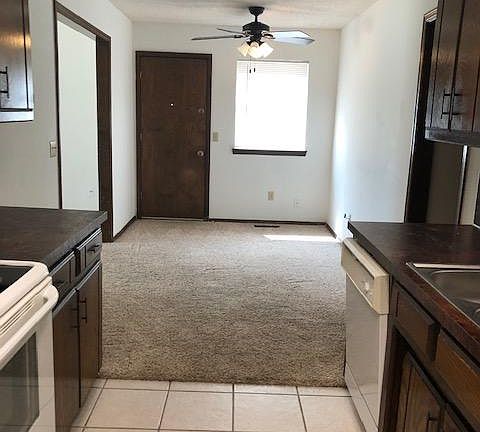 Dining area with door leading to fenced backyard - you mow & edge the extra enclosed yard