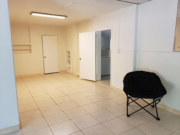 Great room continued, built-in shelving with door open to adjoining kitchen