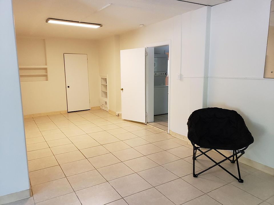 Great room continued, built-in shelving with door open to adjoining kitchen