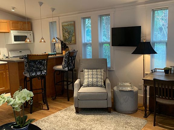 The chair is a recliner and the stool swivels. This is the angle from one of the entry doors. Notice the microwave, coffee maker and TV which has a remote. This picture shows some of the Furnished aspect of the apartment which is available to you.