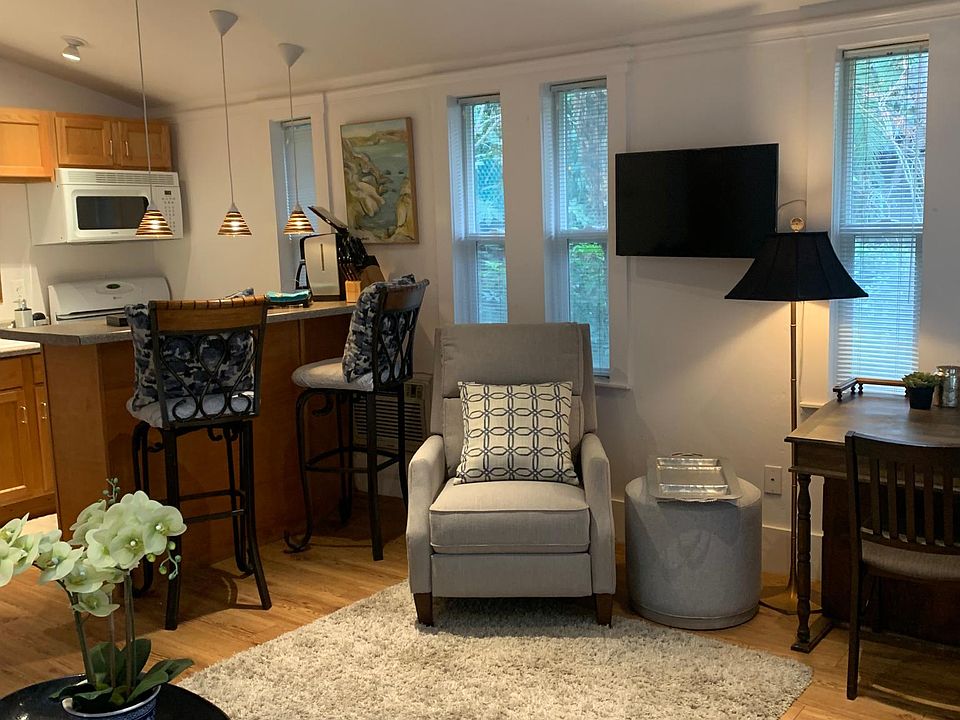 The chair is a recliner and the stool swivels. This is the angle from one of the entry doors. Noyice the microwave, coffee maker and TV which has a remote. This picture shows some of the Furnished aspect of the apartment which is available to you,