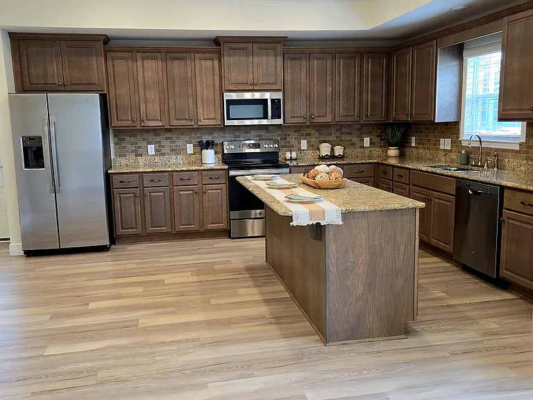 Beautiful open concept kitchen with lots of cabinets including the bar with storage. There is also a separate pantry in the kitchen.