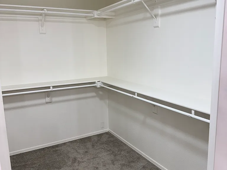 Primary bedroom walk-in closet.