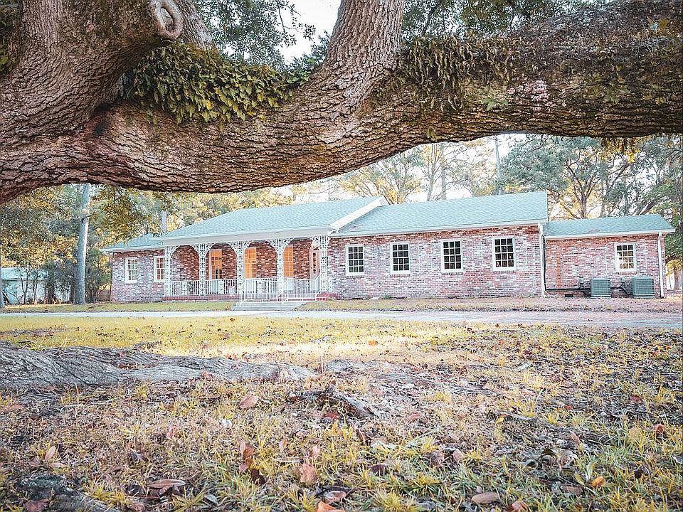 Front drive with live oaks.