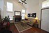 Cozing Living Room with Traditional Log Fireplace and Ceiling Fan