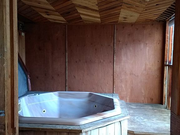 Hot tub enclosure in yard