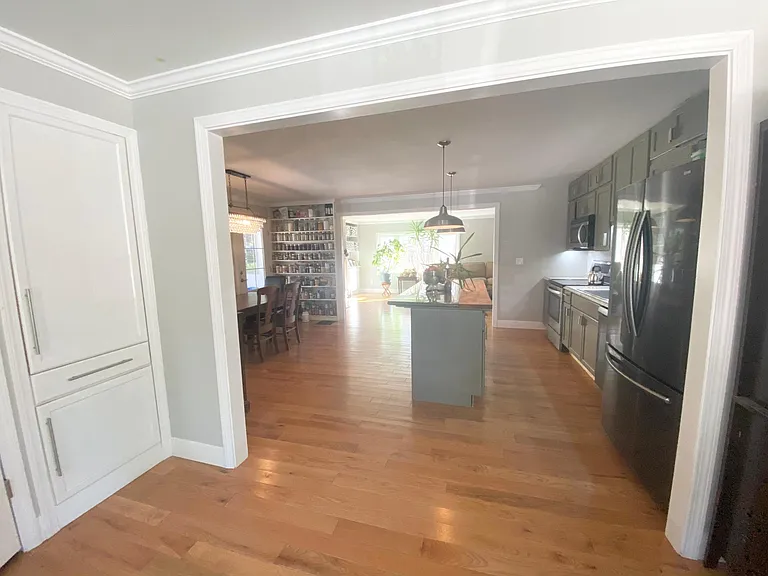 Mud room with large closet and pantry looking into kitchen