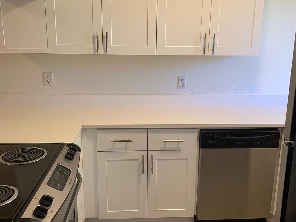 Kitchen with quarts counters and stainless appliances.