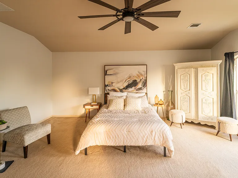Massive Owner's Retreat: Another view of the sprawling primary suite emphasizing the incredible layout, massive floor space, and the wall of windows that floods the entire room with warm, natural sunlight.