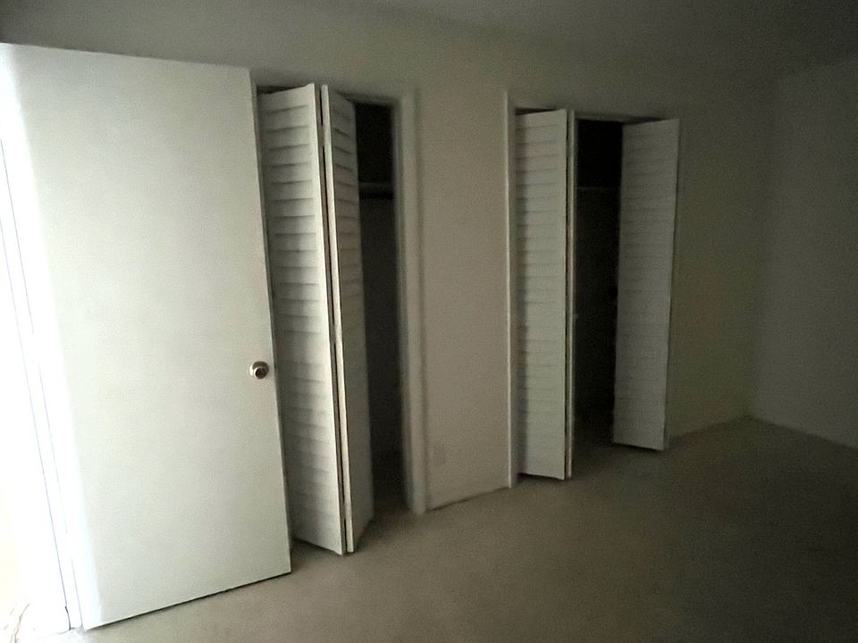 BEDROOM WITH BIFOLD DOORS IN TWO AREAS FOR ACESS TO LARGE CLOSET.AC UNIT FOR BEDROOM ON OPPOSITE WALL