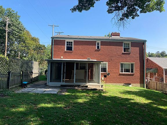 Rear view, fenced backyard. 