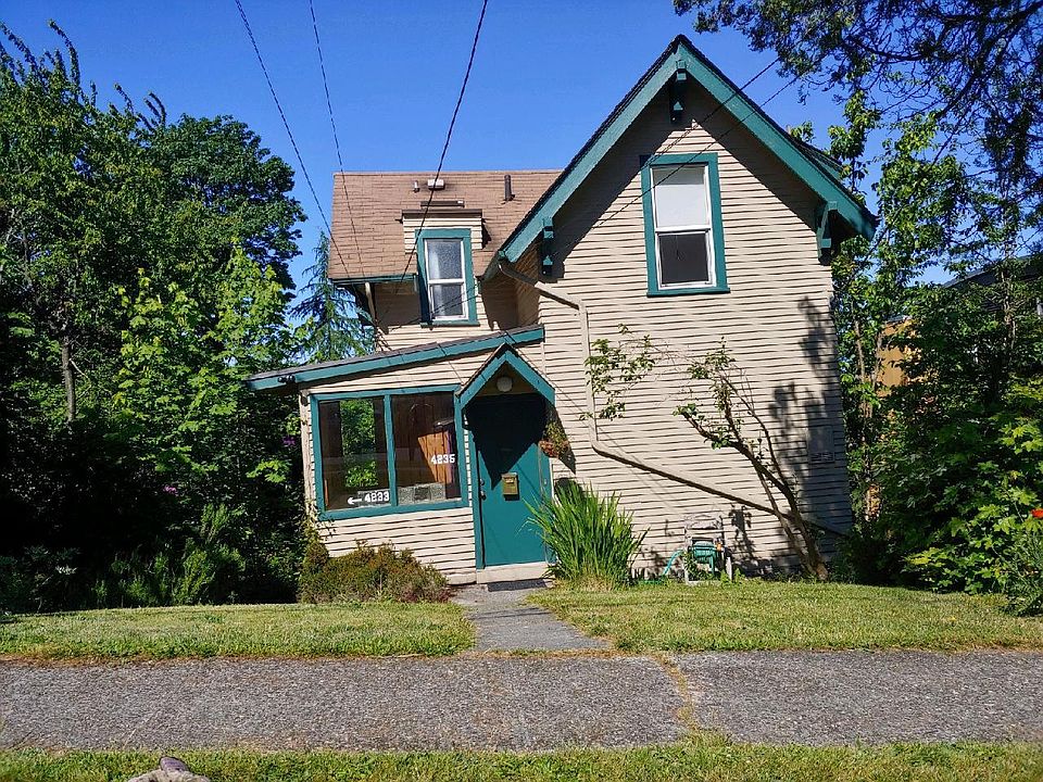 Steet view of house. The green door is the entry to the upper unit. The entry to the lower unit and the gardens is around to the left.