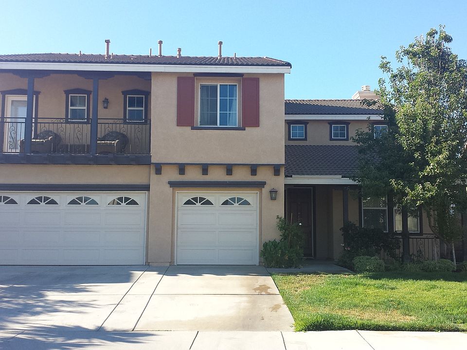 Front Elevation with Wrought Iron Balcony and Porch
