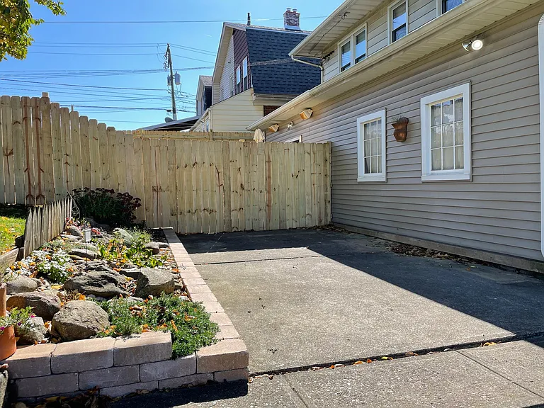 Back patio with rock garden. Vegetable garden plot also on the property.