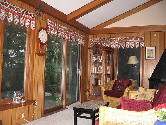Relax in the enclosed side porch that overlooks private garden