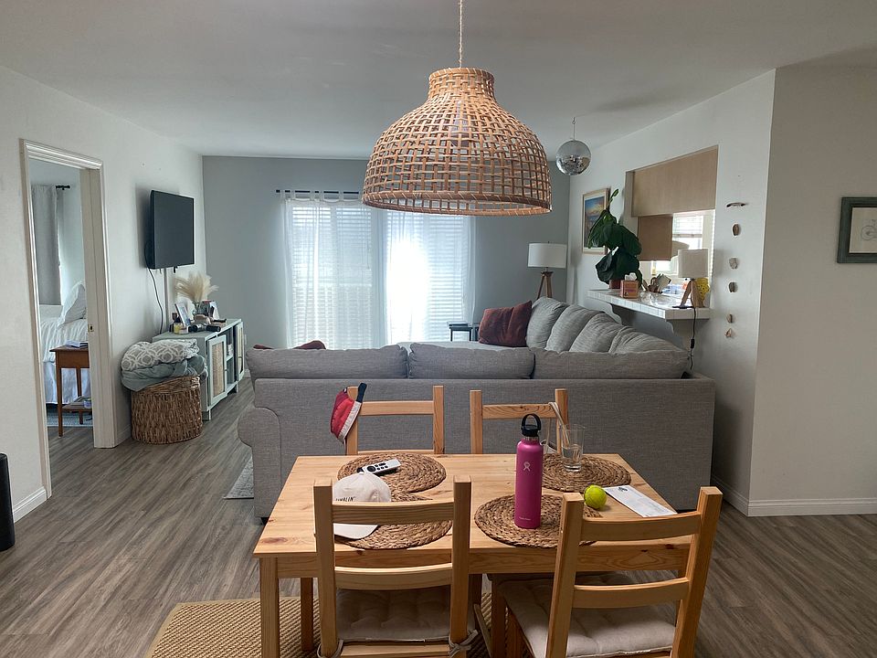 Open concept living room / dining room with pass through and bar counter to the kitchen.