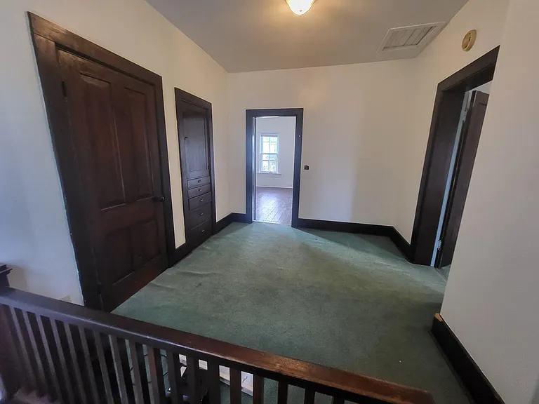 Upstairs hallway leading to two bedrooms and bathroom