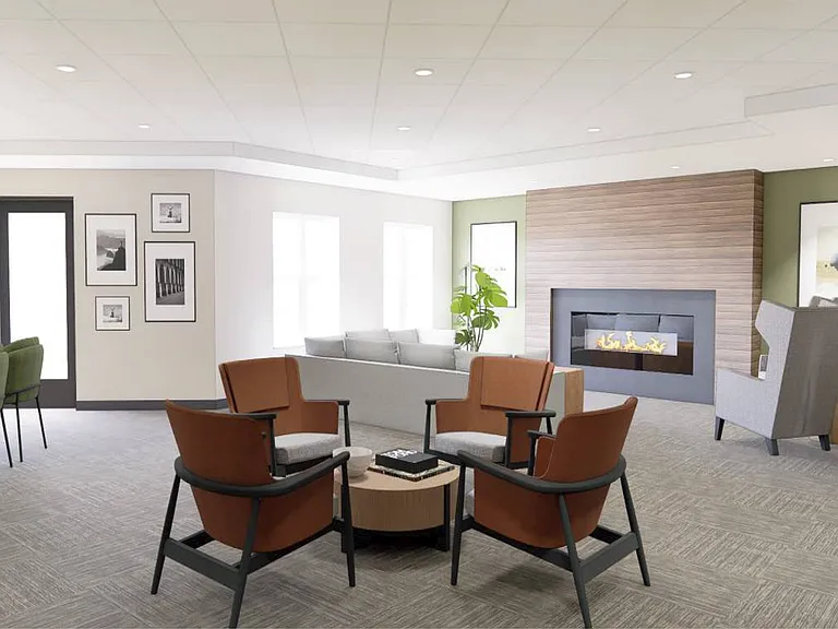 The refreshed community room offers updated finishes and a warm fireplace