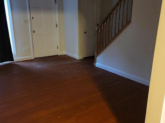 living room entrance shoe closet and stairs