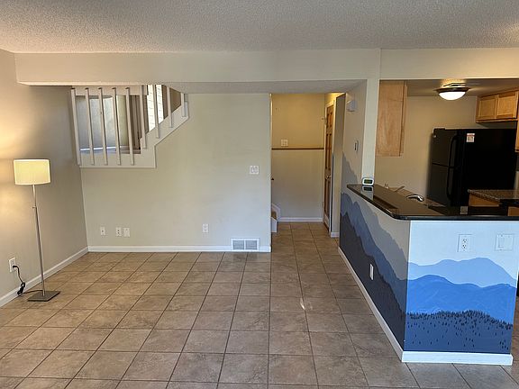 Living room (half of room shown) and kitchen granite bar