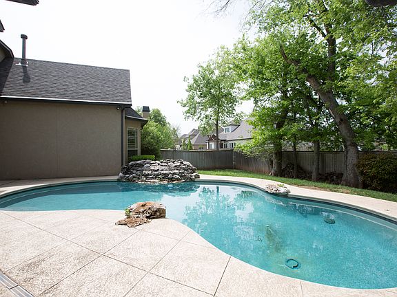 Mature shade trees, full privacy fence and lush landscape add to the serene ambiance.
