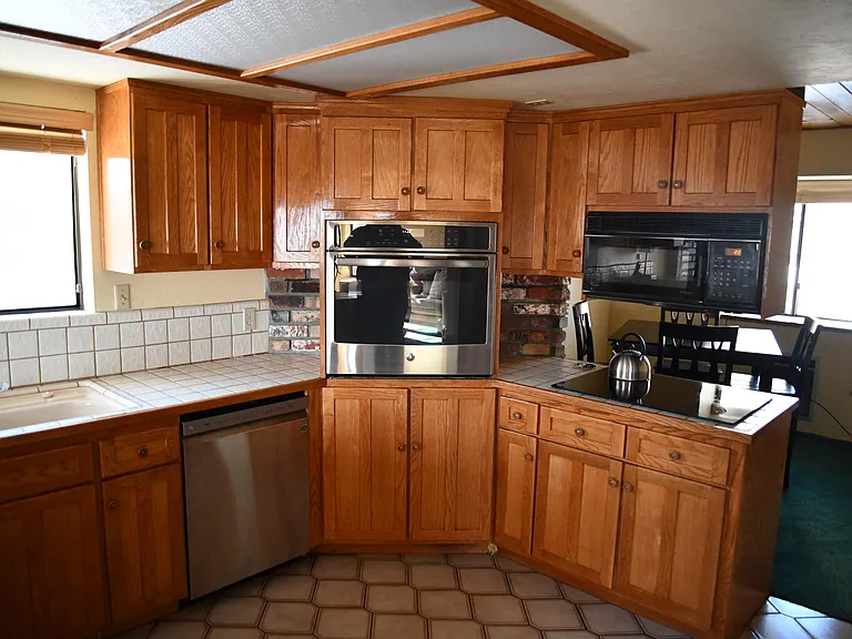 The black microwave has been replaced with a new stainless steel Whirlpool unit.