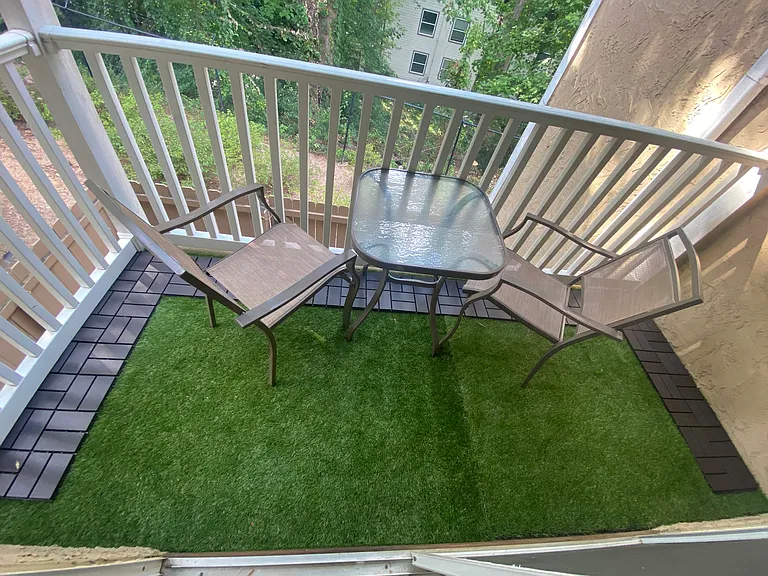 Balcony with plastic turf grass detail. View to woods. You can see Braves fireworks from here!