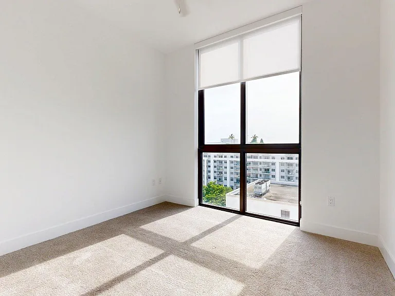 Spacious apartment Bedroom with carpet floors.