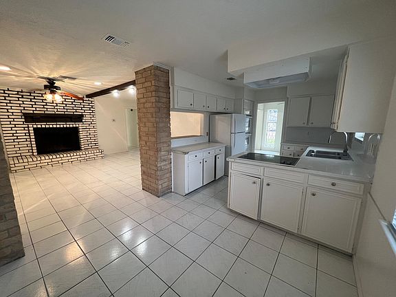 Wide-angle to show the dining room, kitchen and living room
