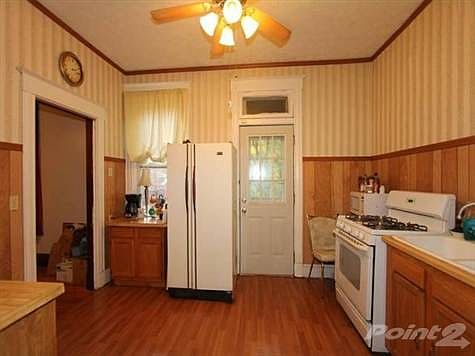 The kitchen is accessed from the dining room, or through a hall way from the front door.  It has laminate floors that make cleaning a snap.  The walkout to the new deck makes grilling and enjoying the outdoors so convenient.