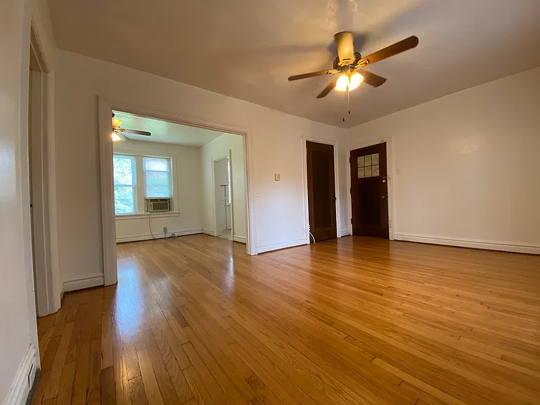 This angle showcases the front entry door and the coat closet directly by it, as well as, a glimpse into the next room. The open floor plan creates a seamless flow between living spaces, making the apartment feel bright, spacious, and easy to personalize.