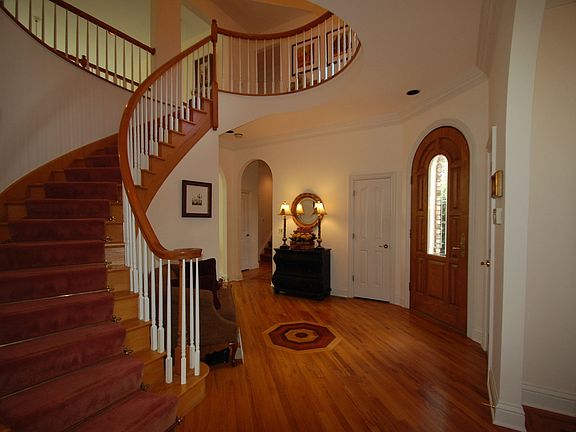 Foyer - Hardwood floor w/walnut inlay, circular stairway