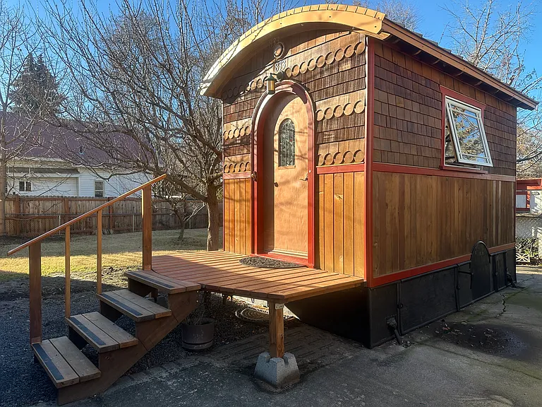 The Lucky Penny, originally built as a tiny house on wheels inspired by the vardos of the Romani people, is now an official ADU (accessory dwelling unit), a backyard cottage on a quiet lot on a tree-lined street.