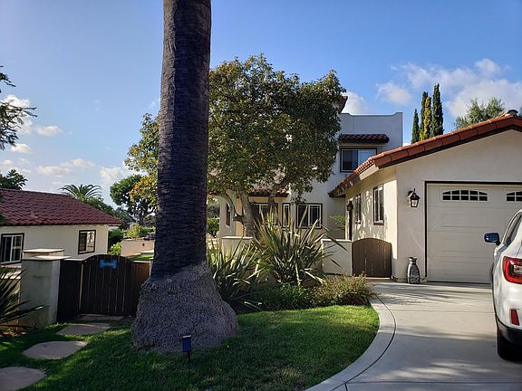 view of the main house with upper and lower garages