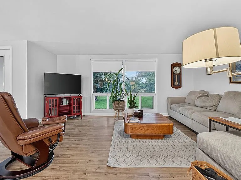 The inviting open floor plan creates a comfortable flow throughout the home, while the wood-burning — Photo 4
