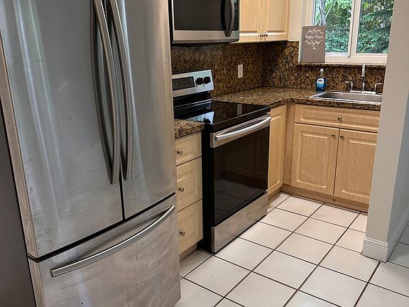 Kitchen with granite countertops and Samsung appliances