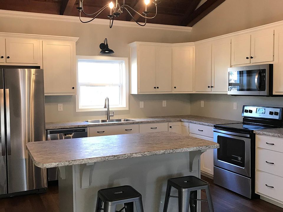 Spacious kitchen with custom cabinets and stainless appliances.