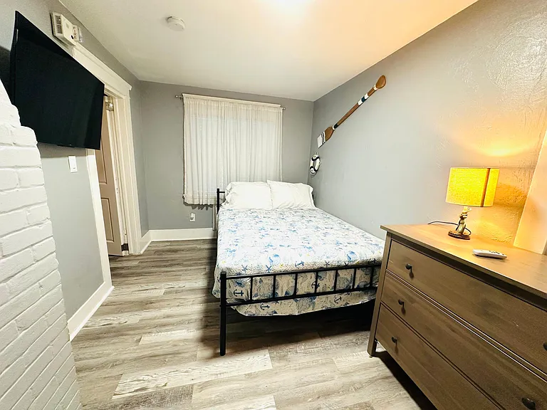 Bedroom with a queen size bed and tv