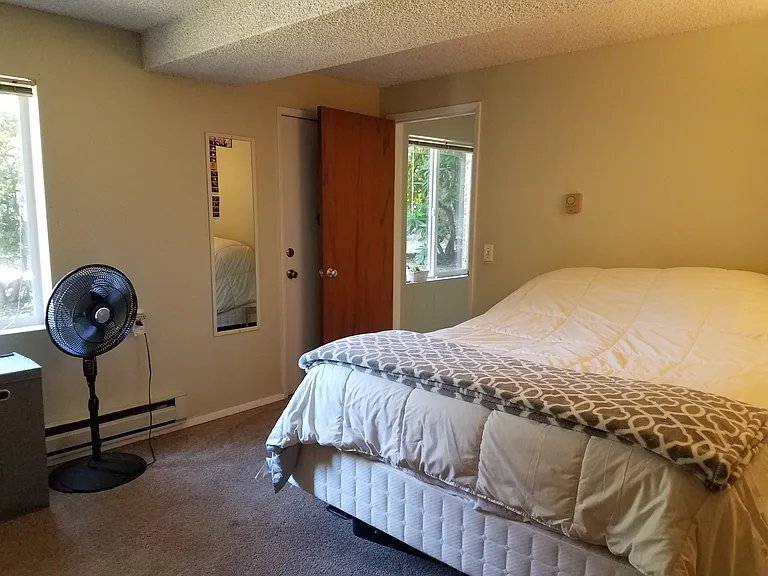 Bedroom. Photos show the unit furnished by previous tenants; the unit will be delivered vacant.